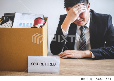 Stressed businessman receive fired letter from Stressed businessman receive fired letter from 56824684