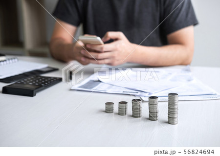 Images of stacking coin pile and Husband using Images of stacking coin pile and Husband using 56824694