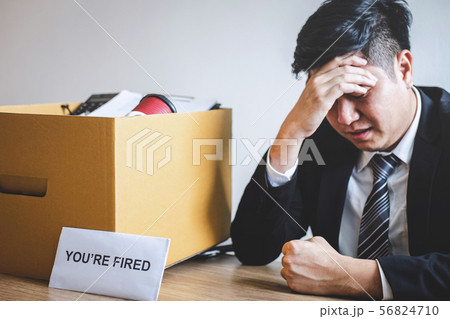 Stressed businessman receive fired letter from Stressed businessman receive fired letter from 56824710