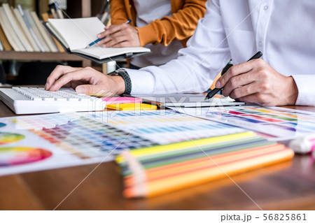 Two colleague creative graphic designer working on 56825861