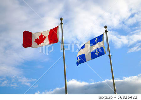 quebec canada flags waving in blue sky national 56826422