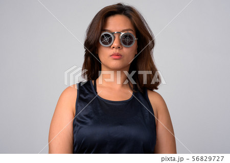 Portrait of young beautiful Asian woman wearing sunglasses with target design 56829727