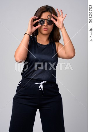 Portrait of young beautiful Asian woman wearing sunglasses with target design Portrait of young beautiful Asian woman wearing sunglasses with target design 56829732