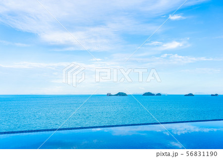 Beautiful outdoor swimming pool with sea ocean on white cloud blue sky background 56831190