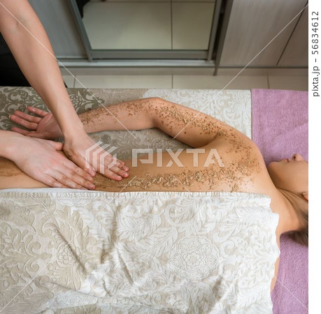 Top view of girl getting procedure body scrub 56834612