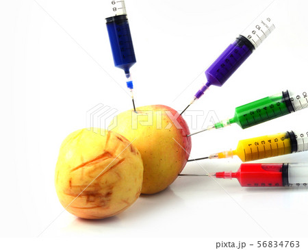 Apple and syringes isolated 56834763