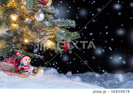 Christmas composition - Christmas tree in the snow, gifts, toy snowman and the inscription Merry 56839678