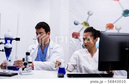 Team of researchers wearing coat in modern research laboratory Team of researchers wearing coat in modern research laboratory 56843010
