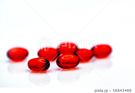 Red soft gel capsule pills isolated on white Red soft gel capsule pills isolated on white 56843466