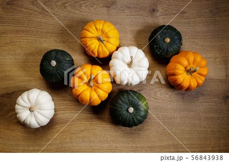 Pumpkins and rad maple leaves on wooden Pumpkins and rad maple leaves on wooden 56843938