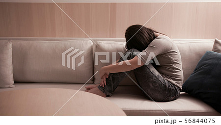 woman feel depressed on sofa 56844075