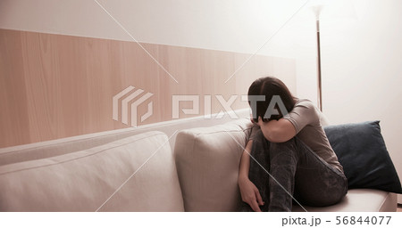 woman feel depressed on sofa 56844077