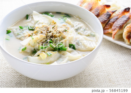 Wonton soup with spring onion served in a white 56845199