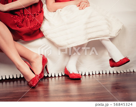 Legs mother and daughter in red shoes Legs mother and daughter in red shoes 56845324