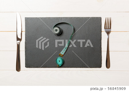 Top view of slate plate, fork and measure tape in 56845909