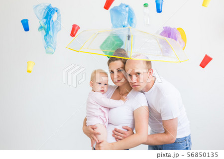 World Environment Day, plastic recycling problem and environmental disaster concept - Sad family World Environment Day, plastic recycling problem and environmental disaster concept - Sad family 56850135