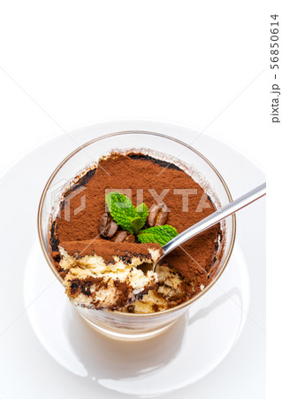 Classic tiramisu dessert in a glass cup on the plate on white background with clipping path 56850614
