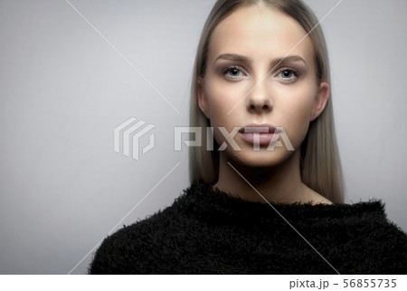 Portrait of a young blonde woman with fury jacket 56855735