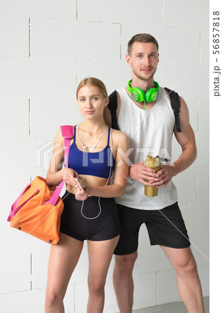 Sport couple - man and woman after fitness exercise on the white background. 56857818