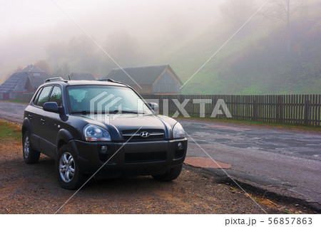 suv on the road side in fog suv on the road side in fog 56857863