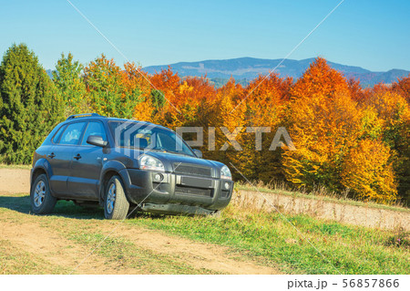suv on the gravel country road side in mountains suv on the gravel country road side in mountains 56857866
