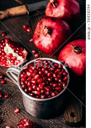 Metal rustic mug full of pomegranate seeds Metal rustic mug full of pomegranate seeds 56858294