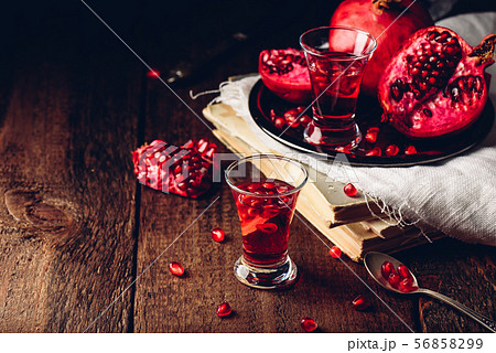 Shot glass of pomegranate cocktail 56858299