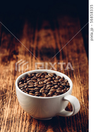 Roasted coffee beans in white cup Roasted coffee beans in white cup 56858335