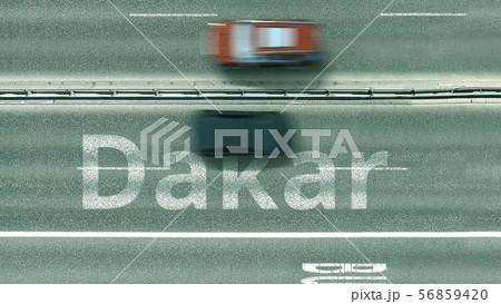 Aerial down view of the motorway with cars revealing Dakar caption. Car travel to Senegal 3D 56859420