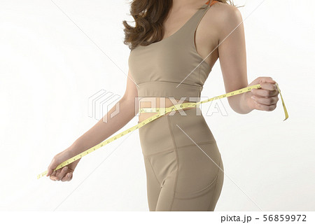 Slim young Asian woman measuring of her body. Slim young Asian woman measuring of her body. 56859972