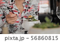 Unrecognized female tourist eats traditional soup with croutons, melted cheese and greens in a Paris 56860815