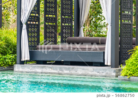 Beautiful outdoor swimming pool in hotel and resort with chair and deck for leisure vacation Beautiful outdoor swimming pool in hotel and resort with chair and deck for leisure vacation 56862750