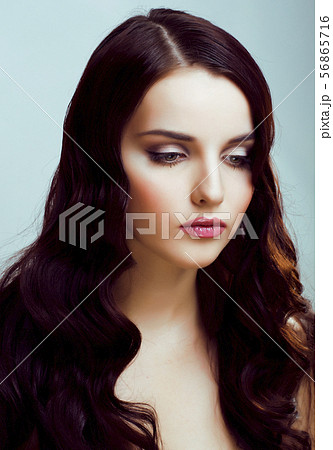 young pretty brunette woman with hairstyle waves, luxury look fashion makeup close up 56865716