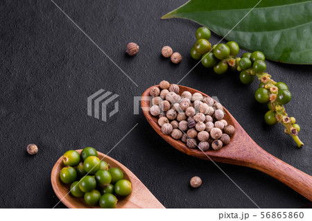 Farm fresh green peppercorns isolated on wood 56865860