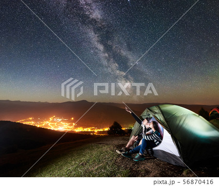 Couple tourists resting at night camping under stars 56870416