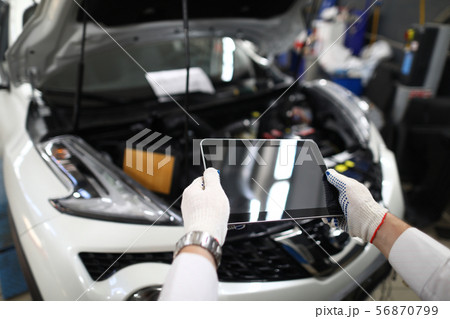 Male hand in white protective gloves hold digital 56870799