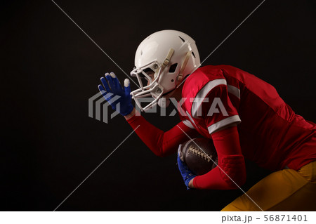 Photo of running sportswoman with rugby ball, in helmet Photo of running sportswoman with rugby ball, in helmet 56871401