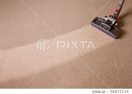Vacuum cleaner is cleaning dirty floor Vacuum cleaner is cleaning dirty floor 56872114