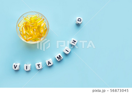 Yellow capsules in the round glass bowl and the Yellow capsules in the round glass bowl and the 56873045