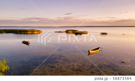 Boats on Lake in summer sunset light. Boats on Lake in summer sunset light. 56873564