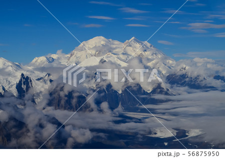Aerial view of Mount Denali - mt Mckinley peak from a plane with glaciers around and blue sky above 56875950