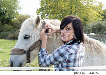 Beautiful young woman and white horse 56878208