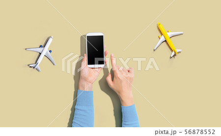 Person holding a smart phone with airplanes 56878552