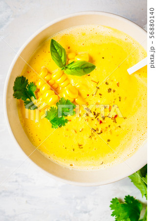 Vegan corn cream soup in white bowl 56880140