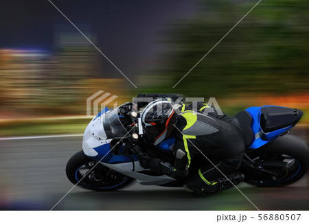 Racing bike rider leaning into a fast corner at Racing bike rider leaning into a fast corner at 56880507