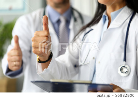 Group of doctors standing in row showing thumb up symbol 56882900