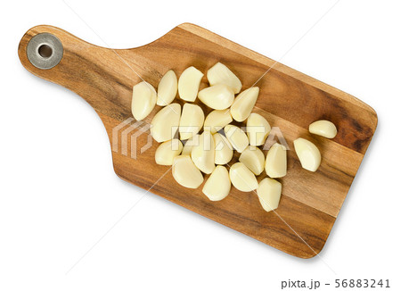 Peeled garlic cloves on wooden cutting board 56883241