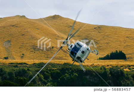 Helicopter In Flight Banking in Mountain Valley Helicopter In Flight Banking in Mountain Valley 56883457