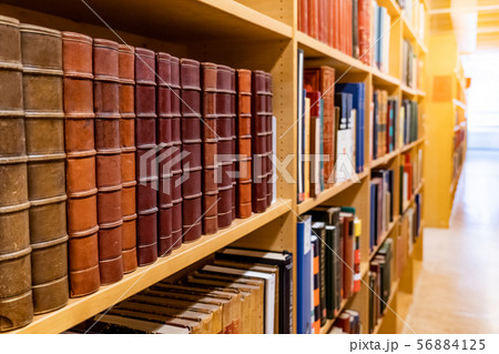 Antique books on wooden bookshelf in library Antique books on wooden bookshelf in library 56884125