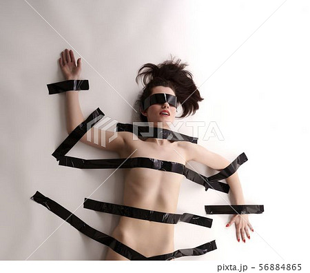 BDSM. Blindfolded nude woman tied with duct tape 56884865
